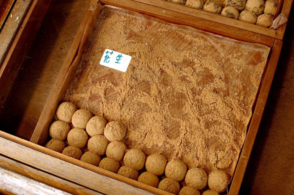 Peanut flavoured mochi balls for sale in a glass case at a street market in Taiwan