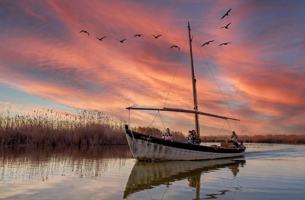 family aboard a boat in La Albufera, Valencia, Spain