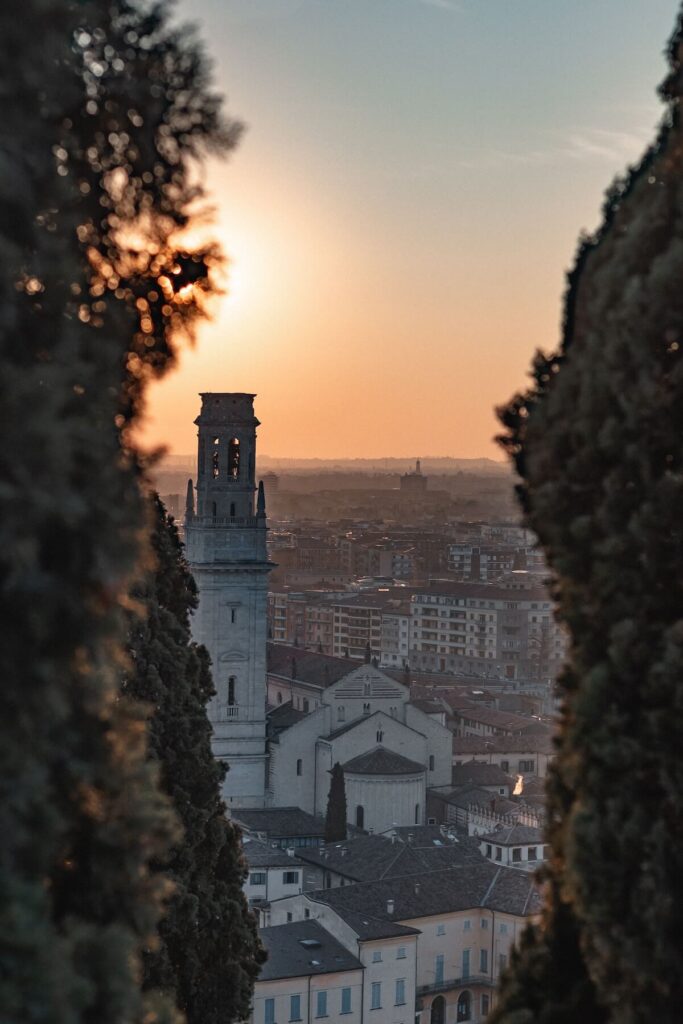 sunset in verona between trees