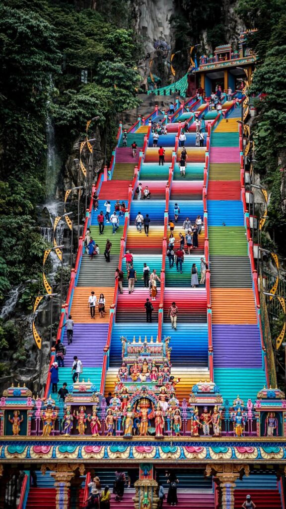 people coming down and going up the stairs of Batu Caves