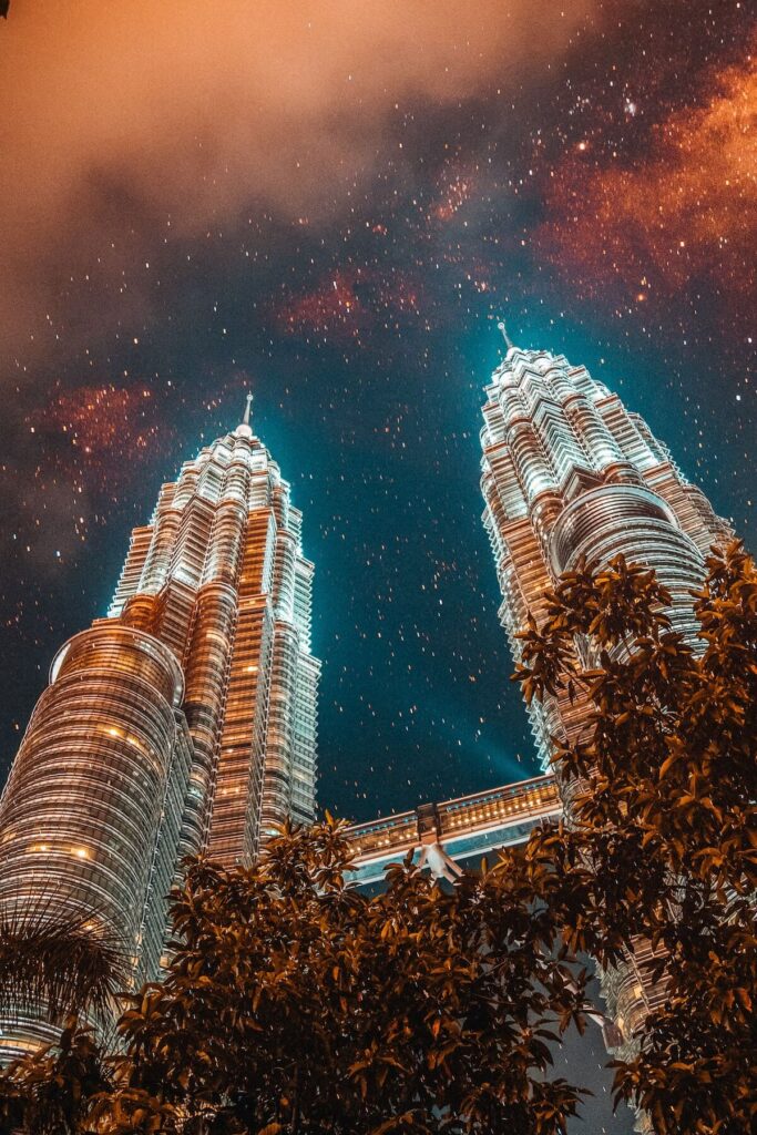 low angle photography of Petronas Twin Towers with beautiful night sky