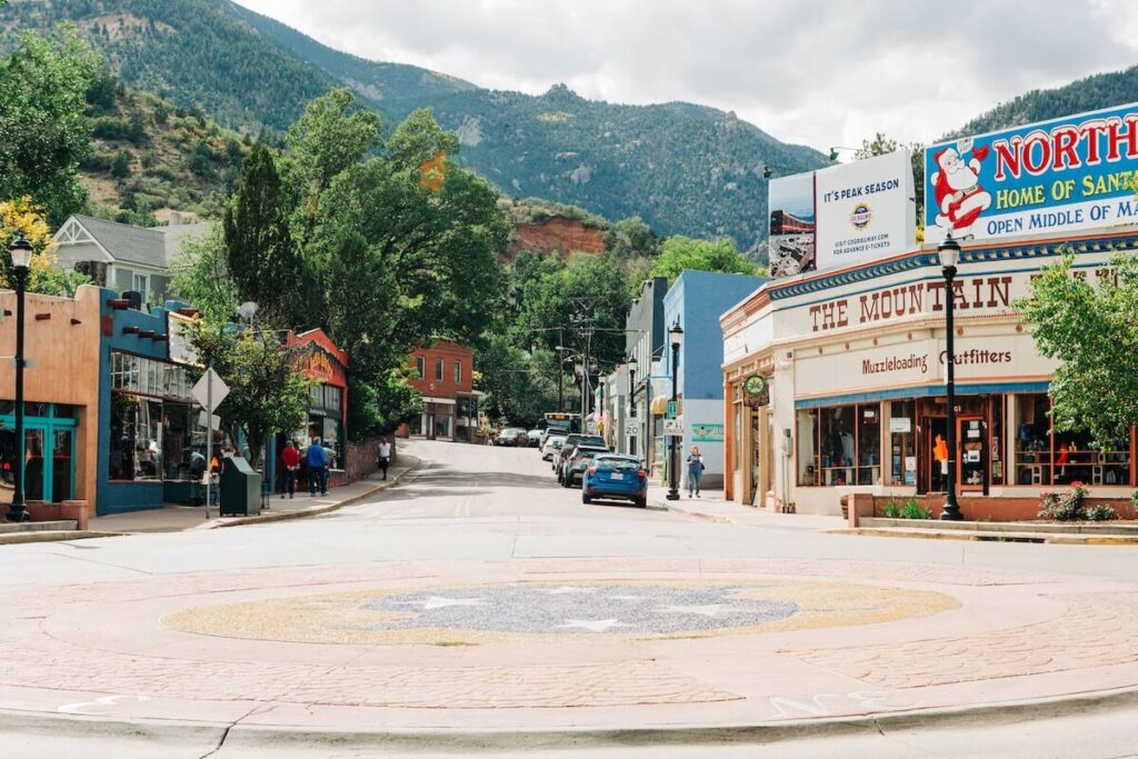 Colorful historical downtown of Manitou Springs near green mountains