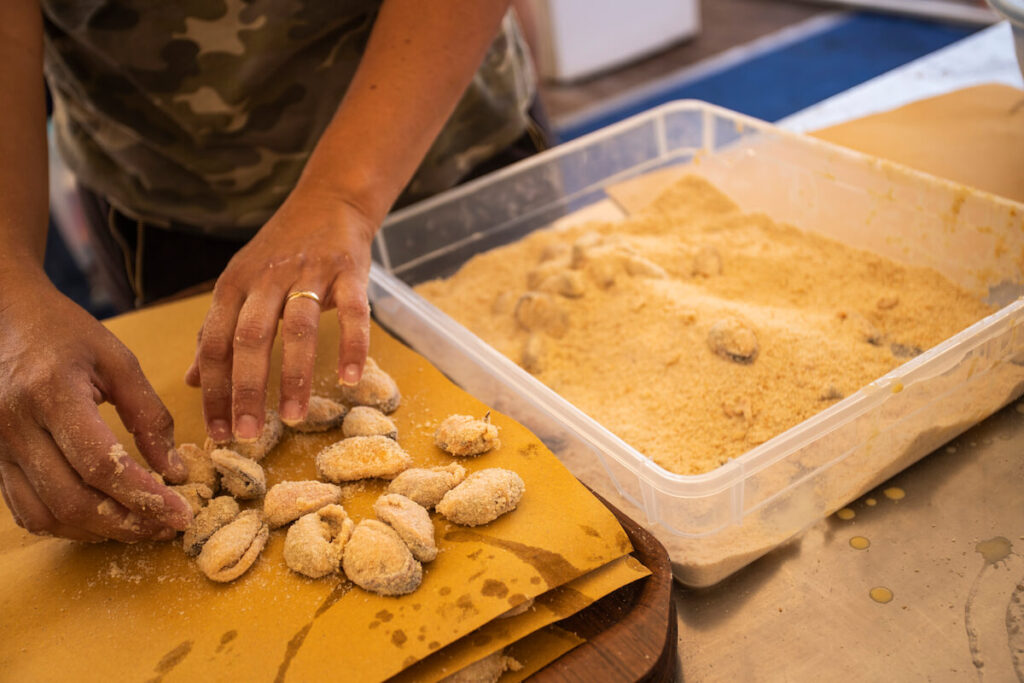 Preparation of fried shellfish in the festival of the Summer Carnival of Muggia, Trieste, Italy