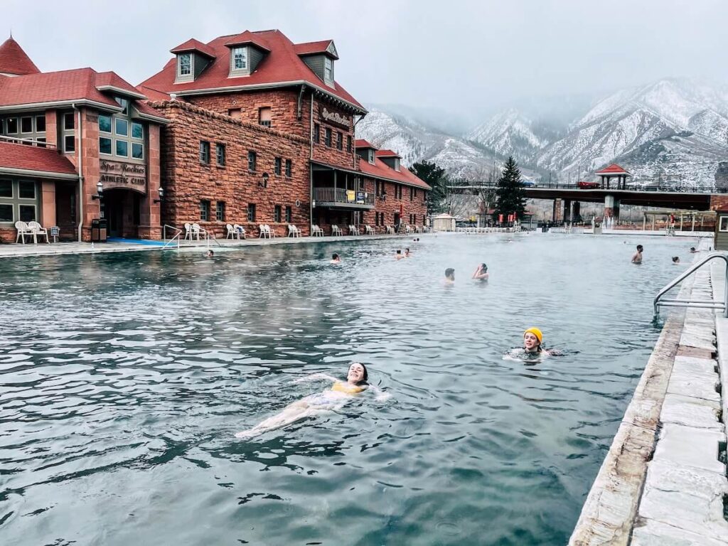 People swimming in steamy water at a spa in Glenwood Springs