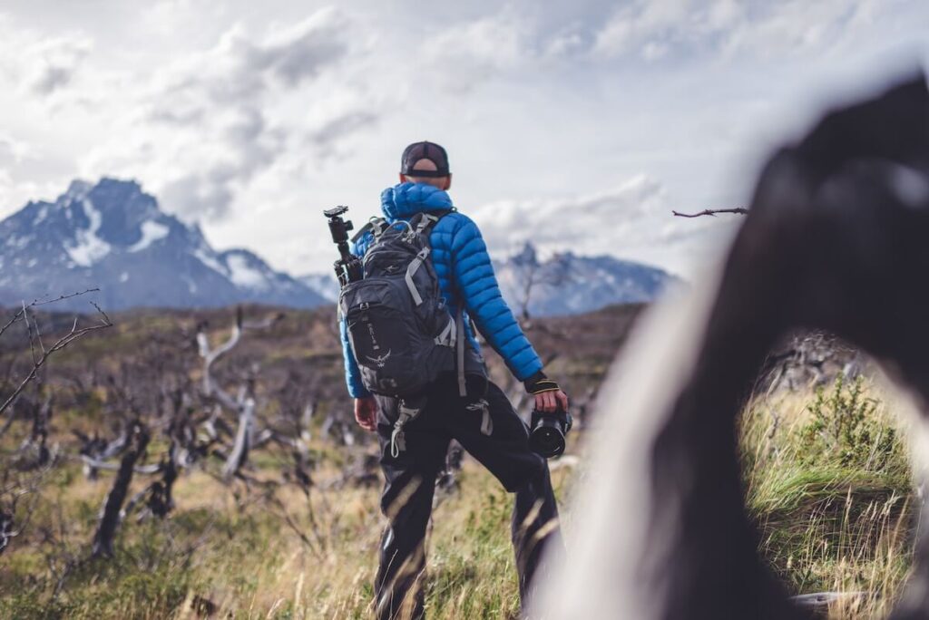 man in blue jacket looking around surrounding in Chilean Patagonia