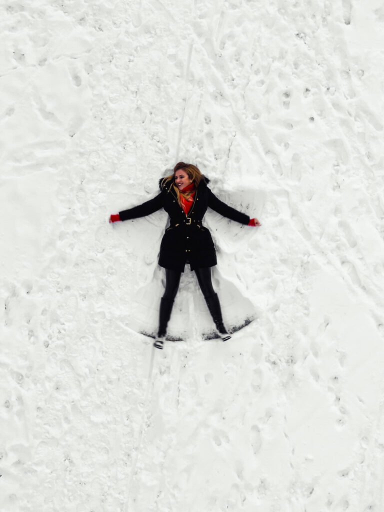 Woman making snow angel