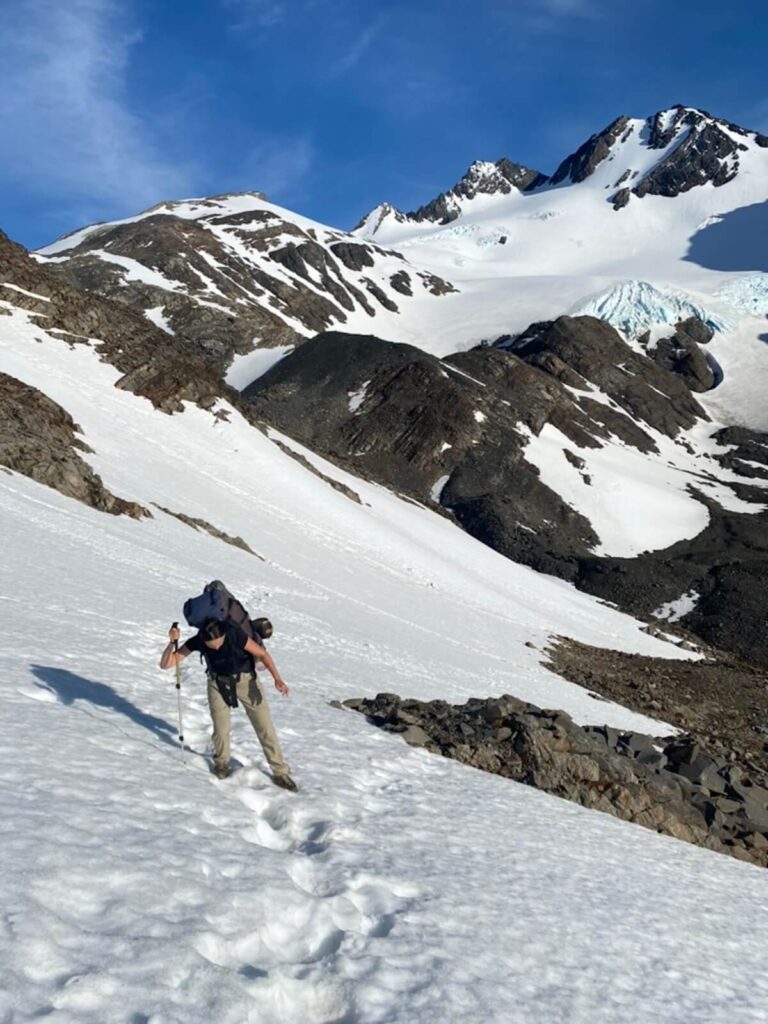 man hiking through snowy mountain in the Chilean Patagonia