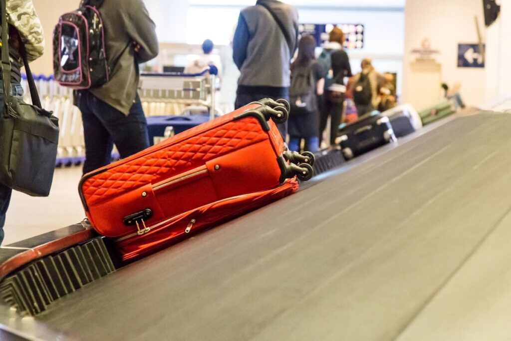 Closeup of luggage bag on airport conveyor belt for pickup
