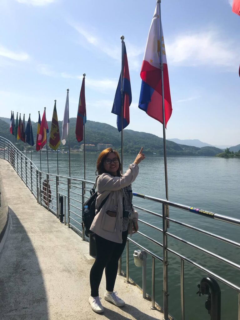 woman posing near flags in ferry
