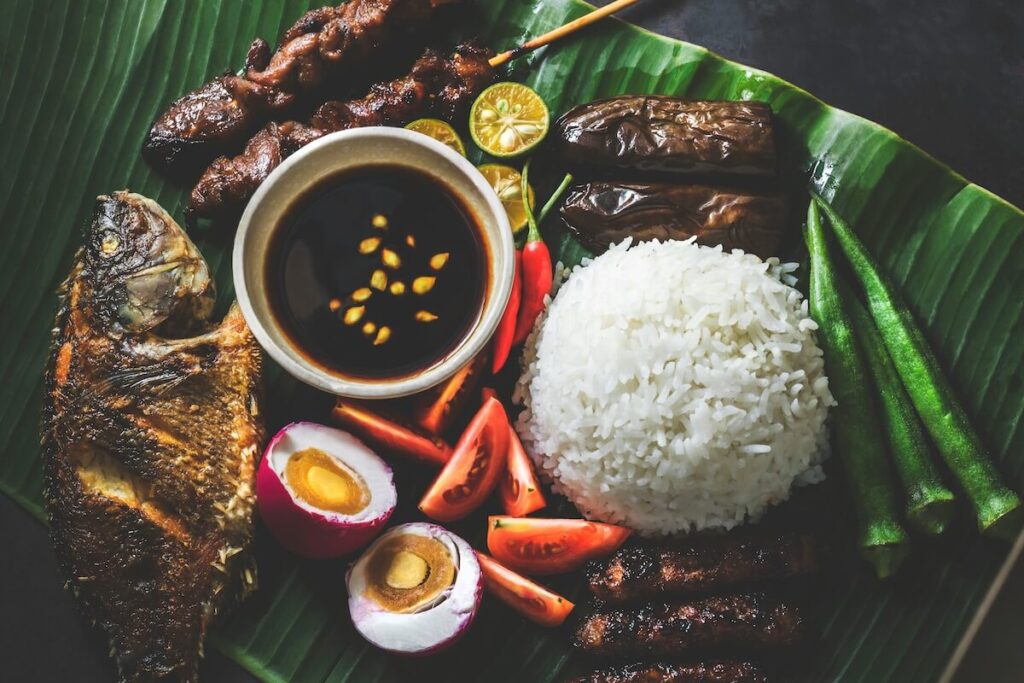 flatlay of assorted Filipino food on banana leaf