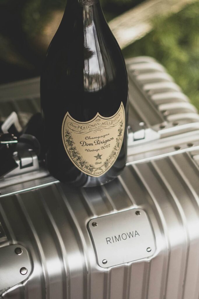 bottle of wine on top of suitcase