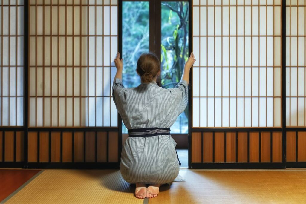 woman wearing kimono opening tatami room door