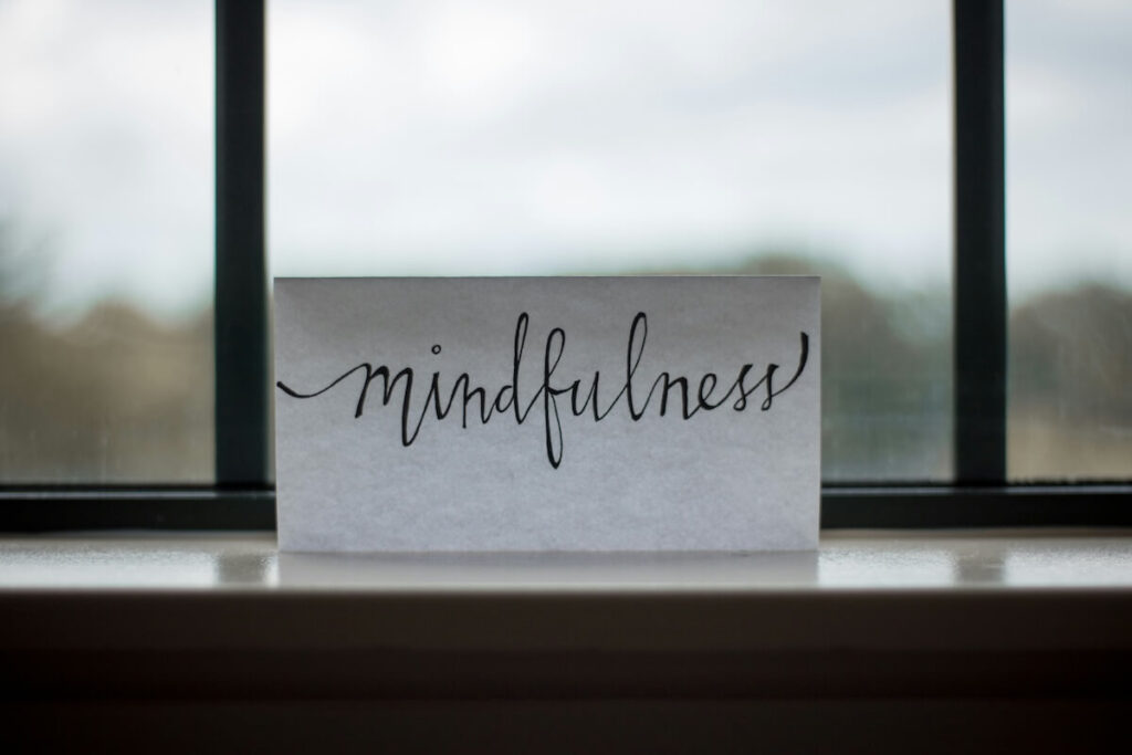 "mindfulness" written on paper near window