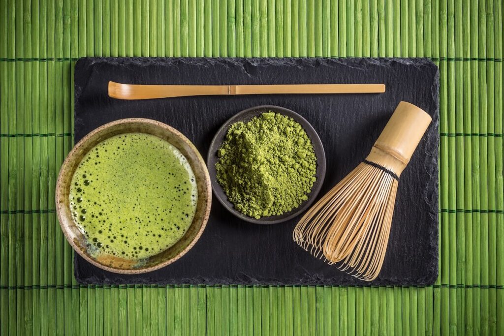 Japanese tea ceremony utensils including bowl, matcha whisk, and bamboo spoon