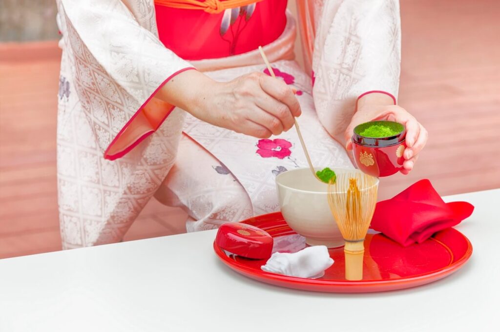 woman spooning matcha from caddy