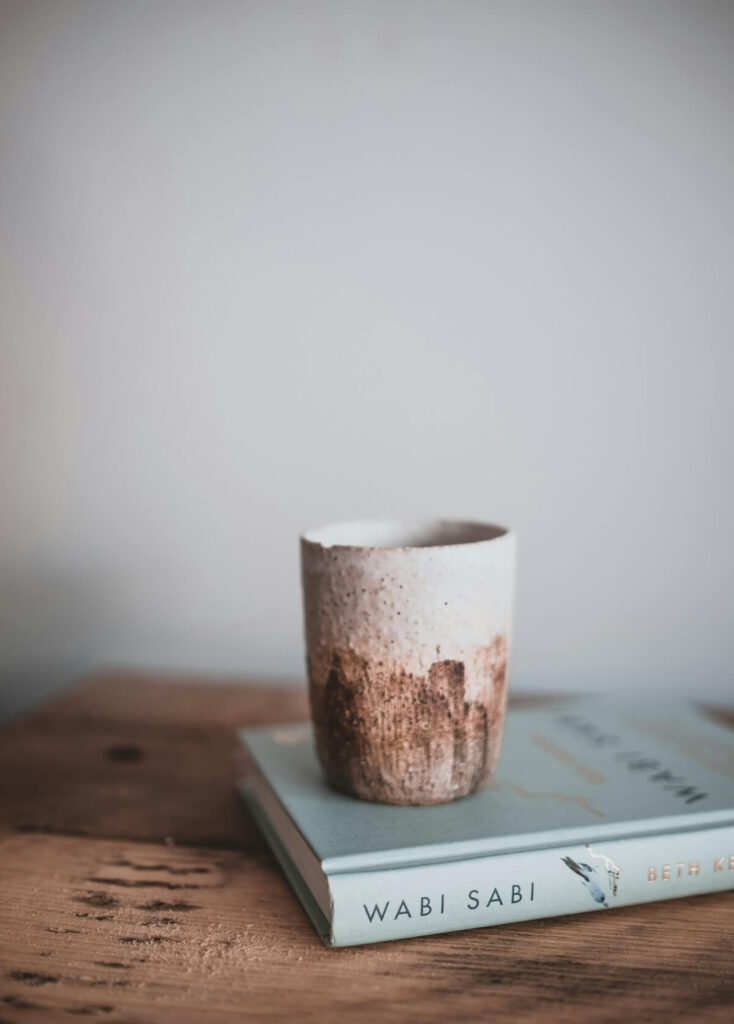 artsy cup on top of Wabi Sabi book