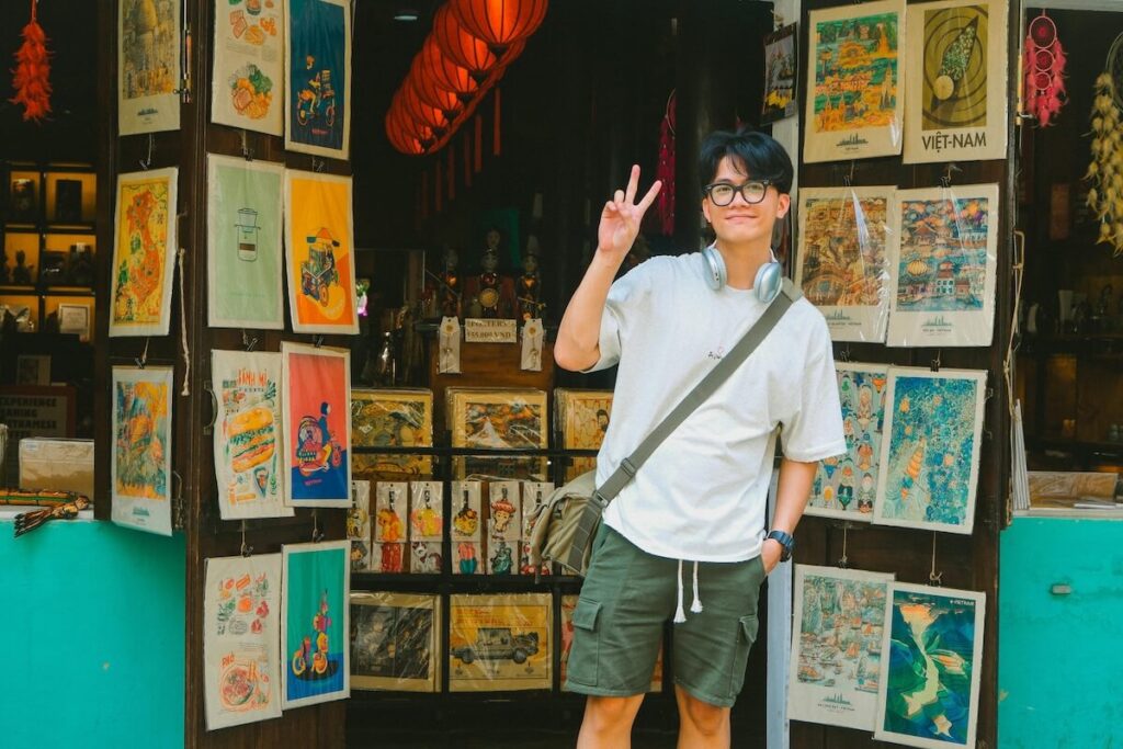 man standing outside a souvenir shop in Vietnam