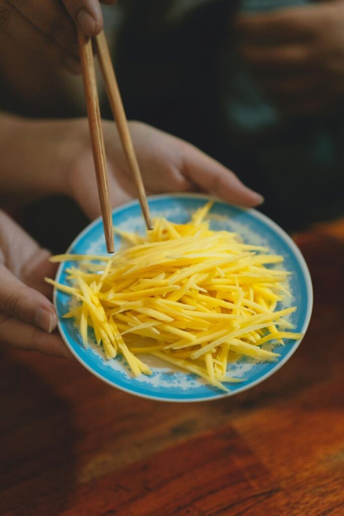 person using Vietnamese chopsticks