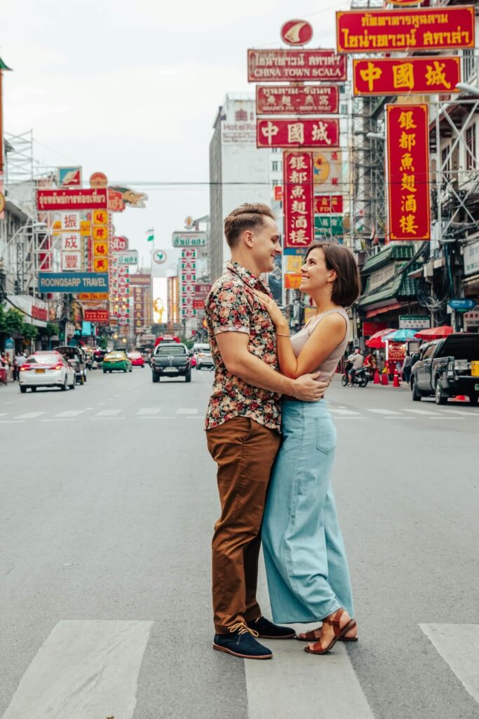 couple staring lovingly at each other while standing in Bangkok Chinatown