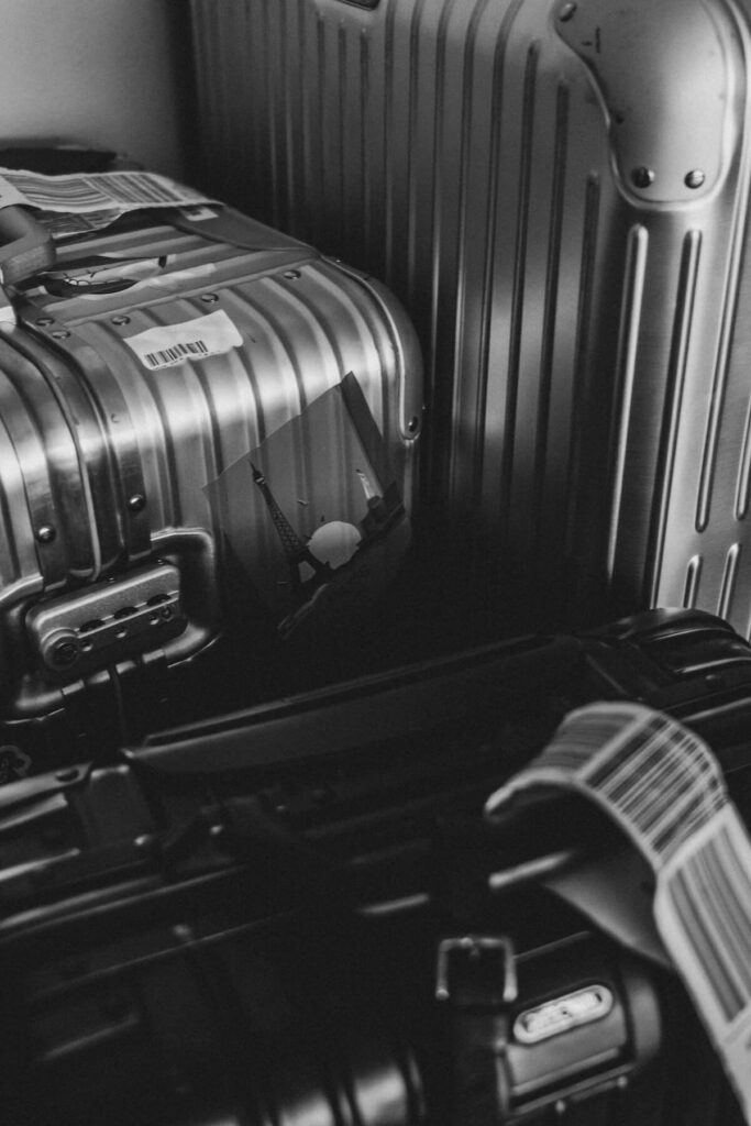 pile of luggage in black and white