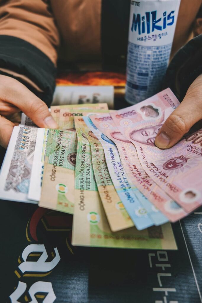 man holding Korean won bills