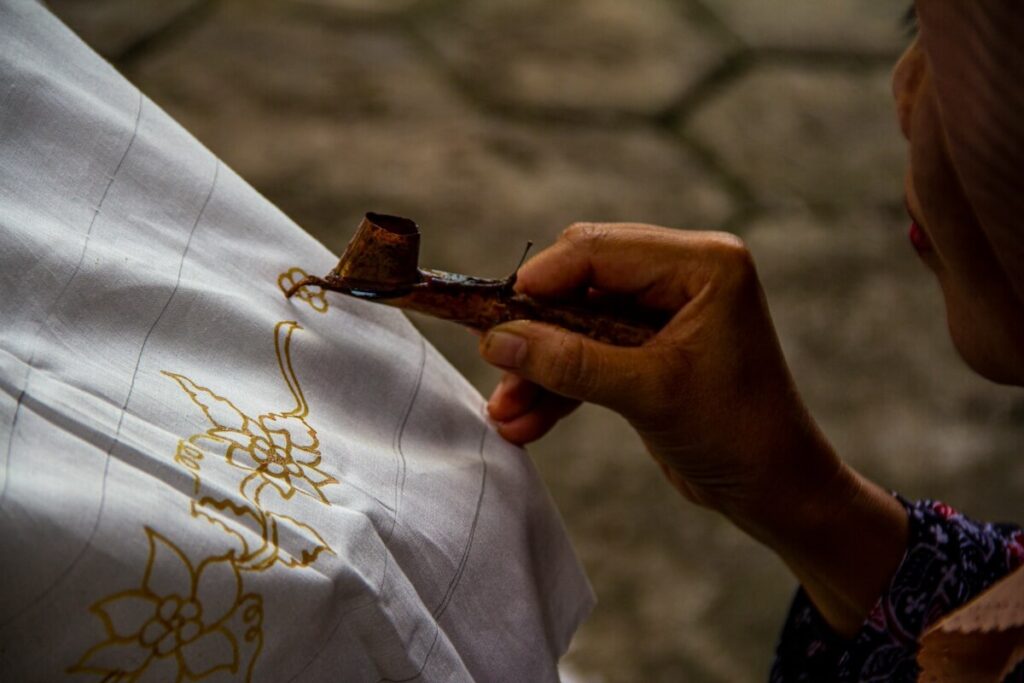 person making batik design