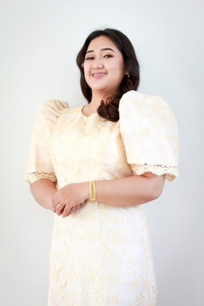 woman wearing terno or Filipiniana dress