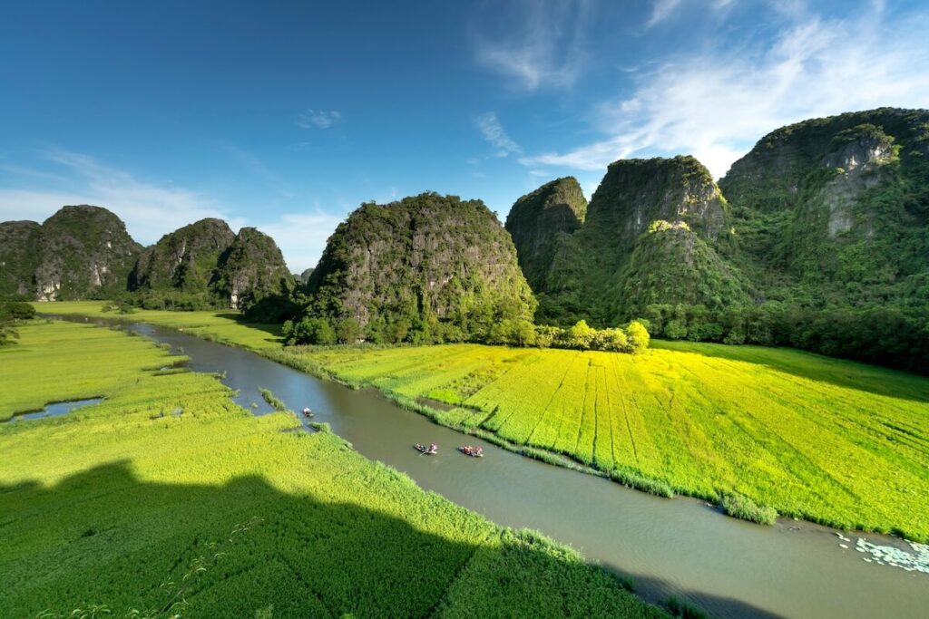 panoramic view of Tam Coc and boat cruising through Ngo Dong River