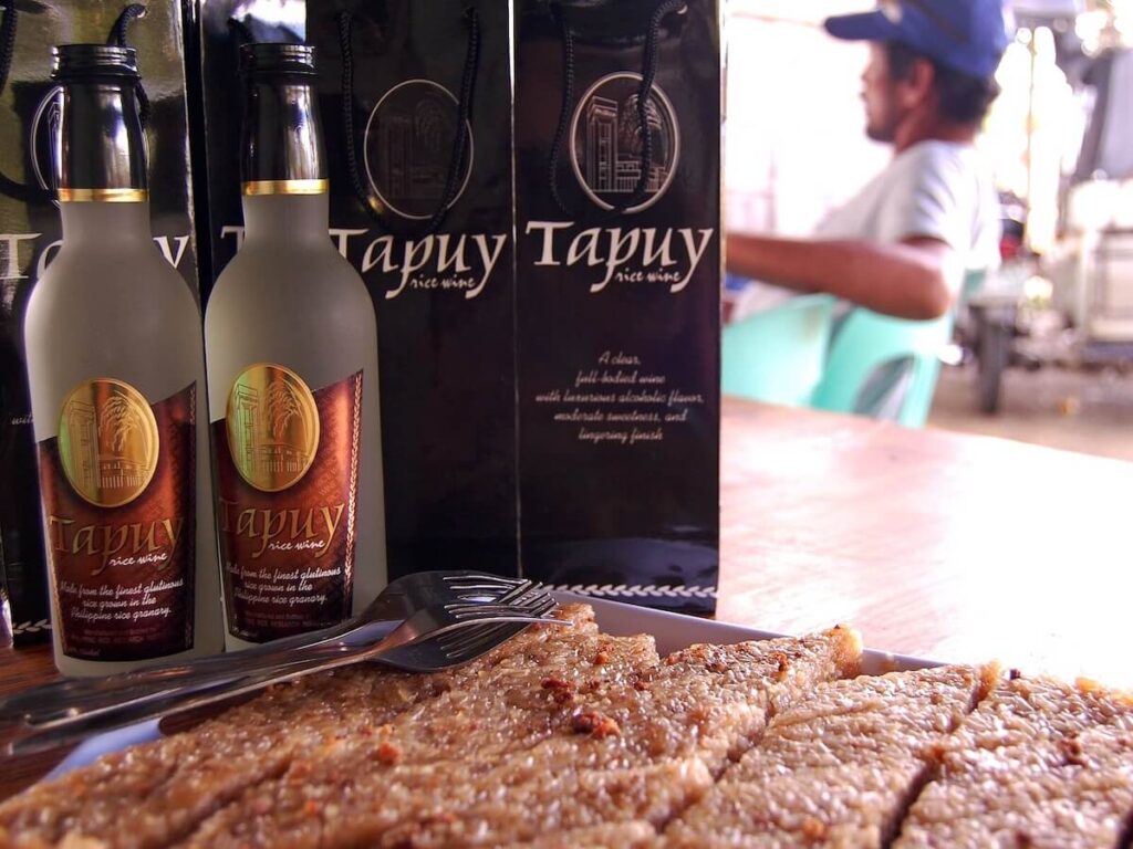 bottles of tapuy and biko for merienda