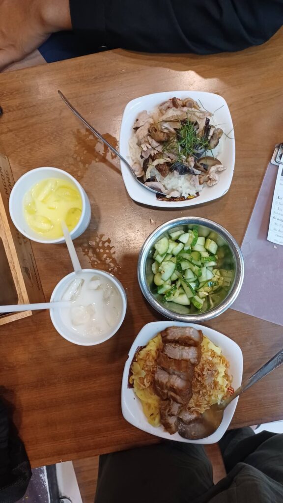 sticky rice bowls, cucumber salad, and drinks at Xoi Yen restaurant in Hanoi