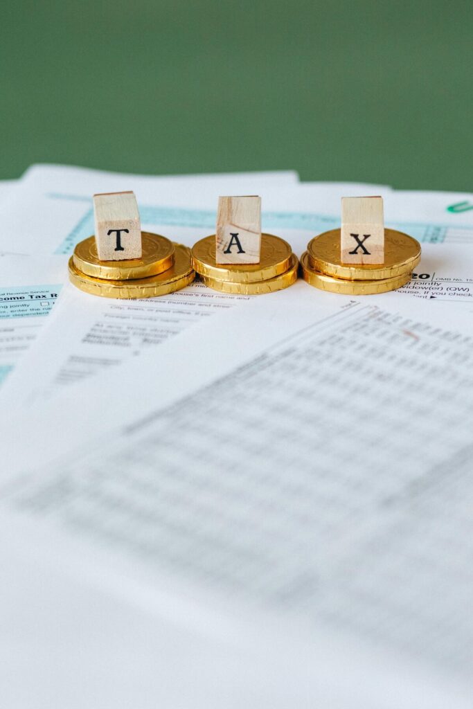 gold coins with cubes spelling out TAX