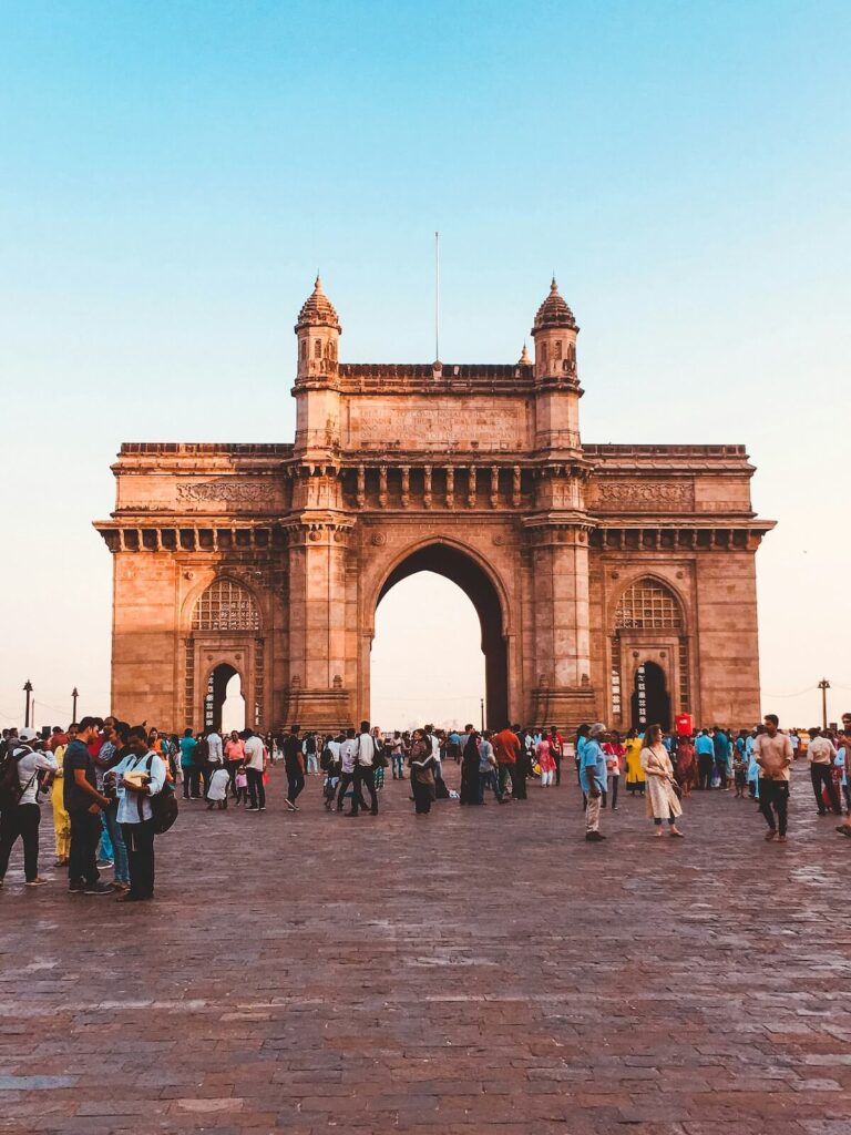 people around Gateway of India at dusk