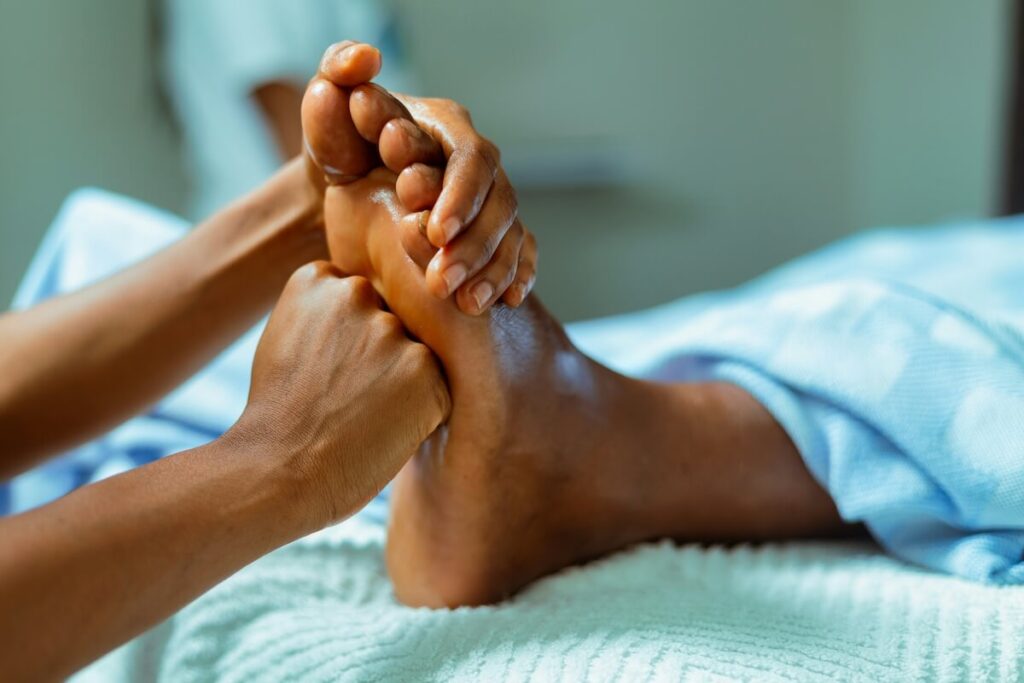 hand massaging foot
