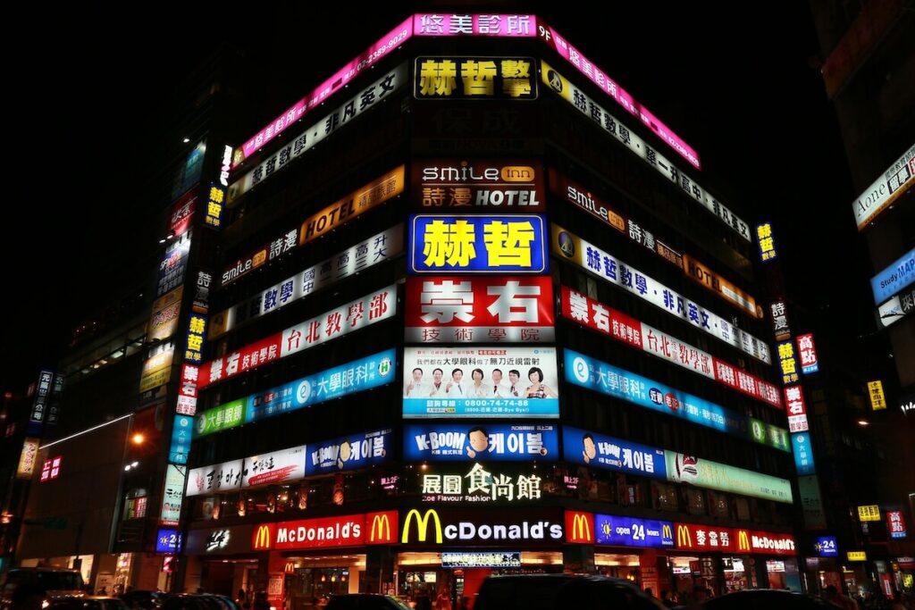 building with various neon signs