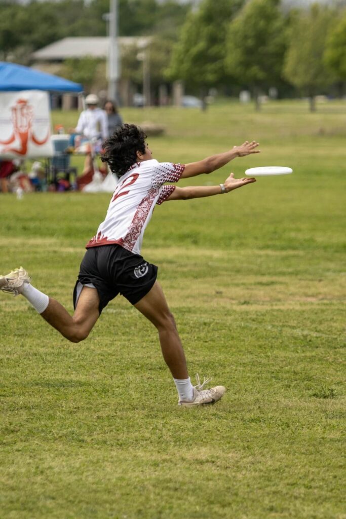 person catching frisbee in a park