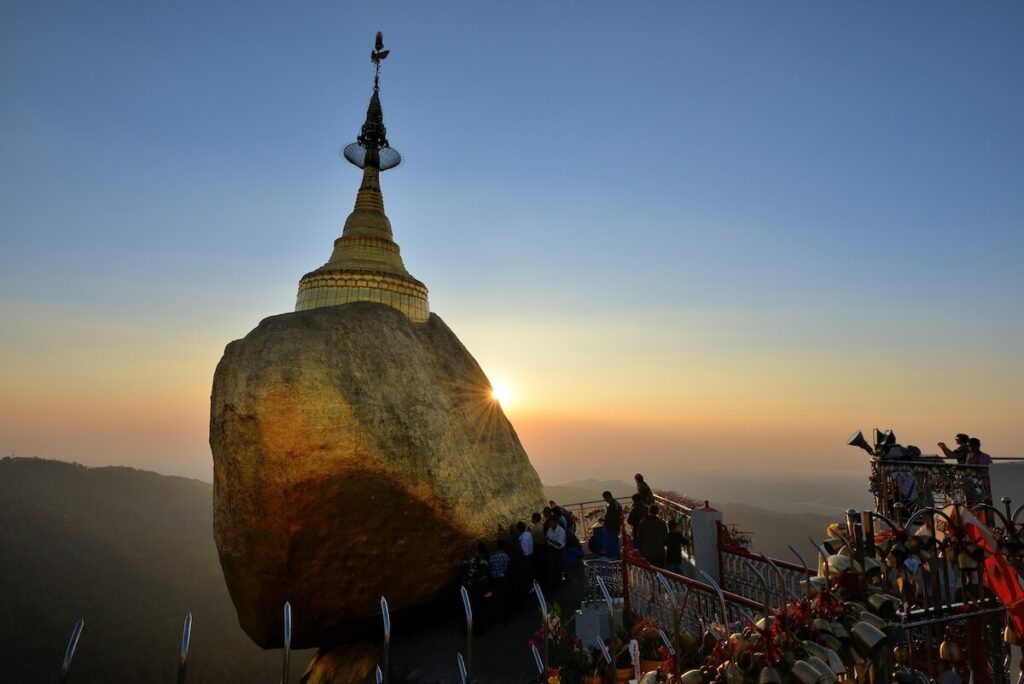 tourists at the Kyaiktiyo Pagoda at sunrise