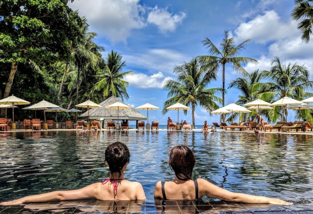 two women lounging at pool