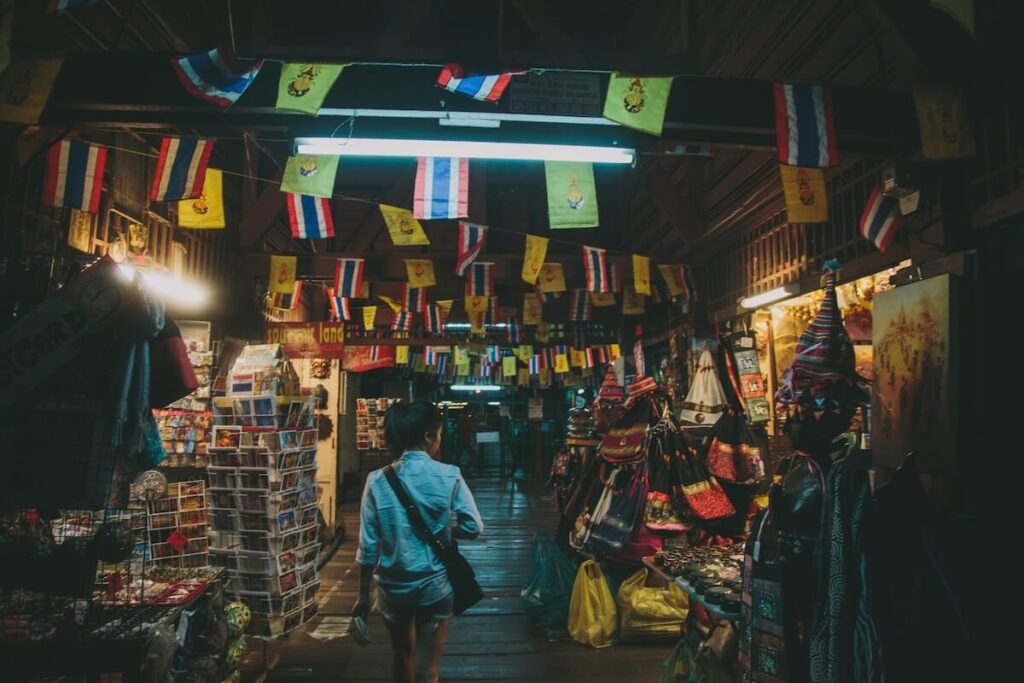 woman walking at an alley in a Bangkok night market