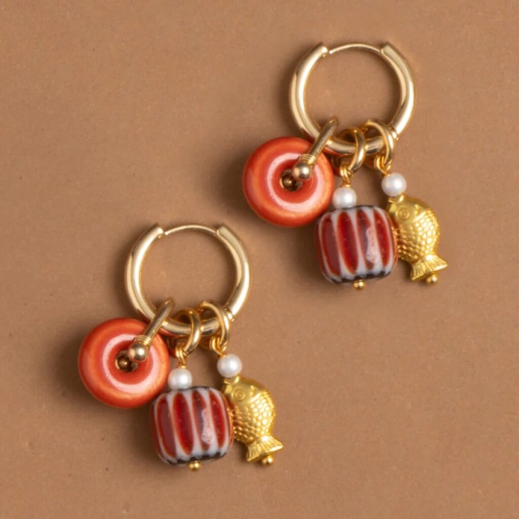 beaded earrings on brown background
