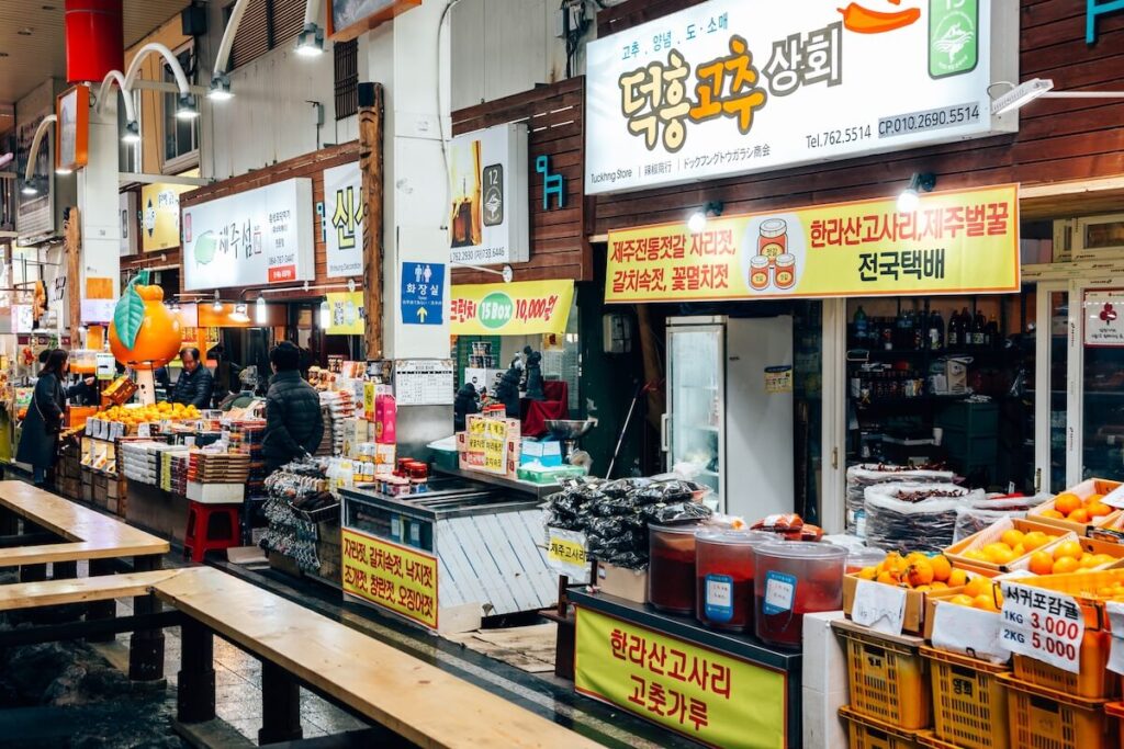 stalls selling hallabong (Jeju tangerines) inside Seogwipo Maeil Olle Market