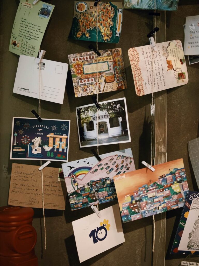 assortment of Singapore postcards hanging