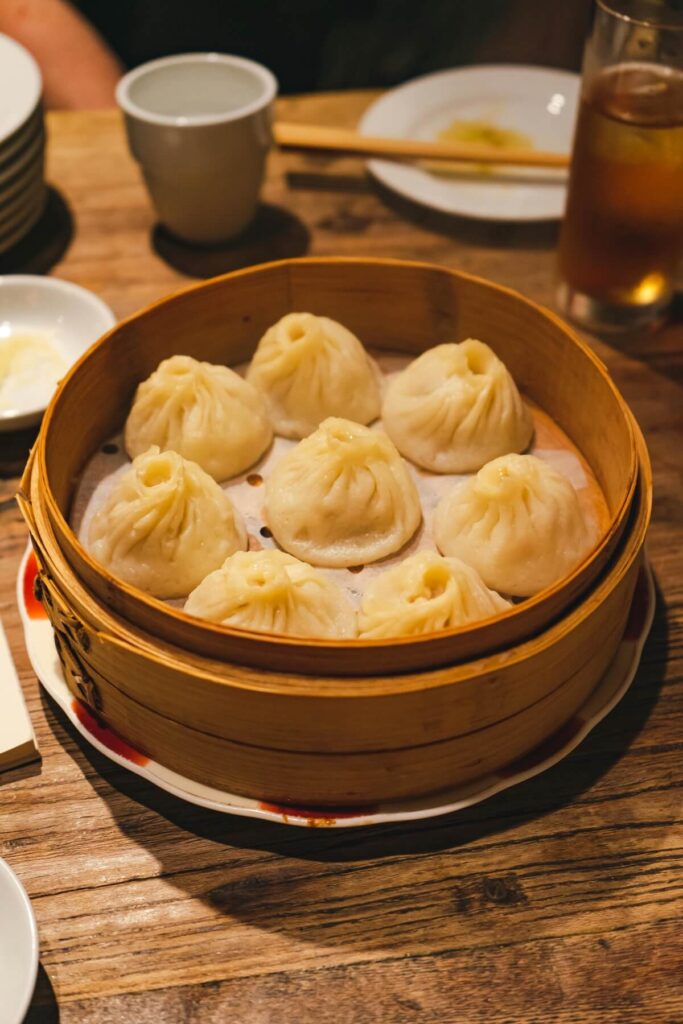 pieces of xiaolongbao on a bamboo steamer