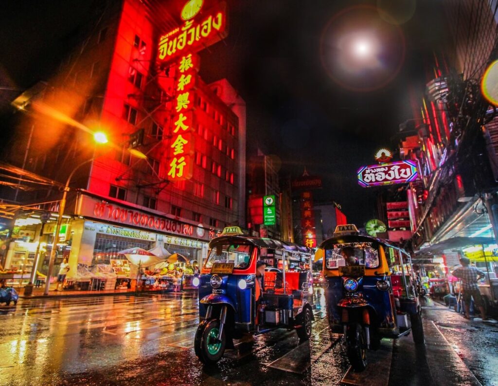 tuktuks parked in Bangkok Chinatown at night