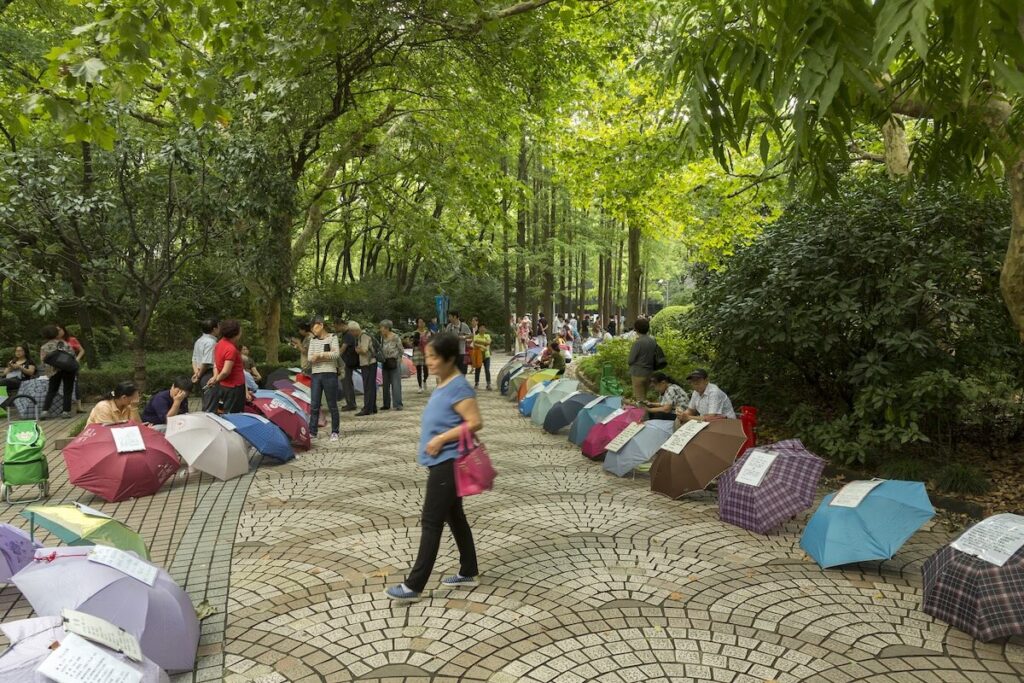 people and umbrellas at the People's Park Marriage Market
