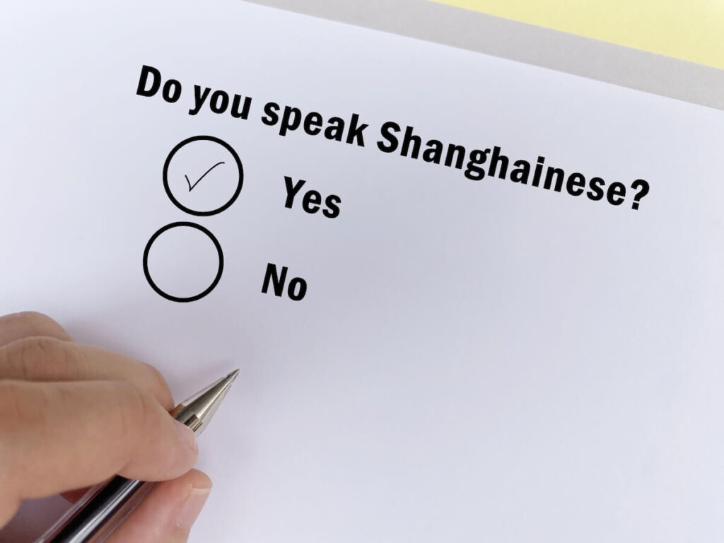 hand answering a form asking "Do you speak Shanghainese?"