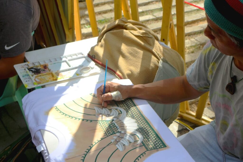 artist handpainting on a shirt