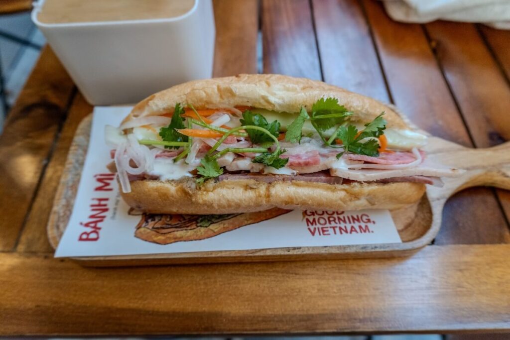 banh mi on top of wooden tray and paper