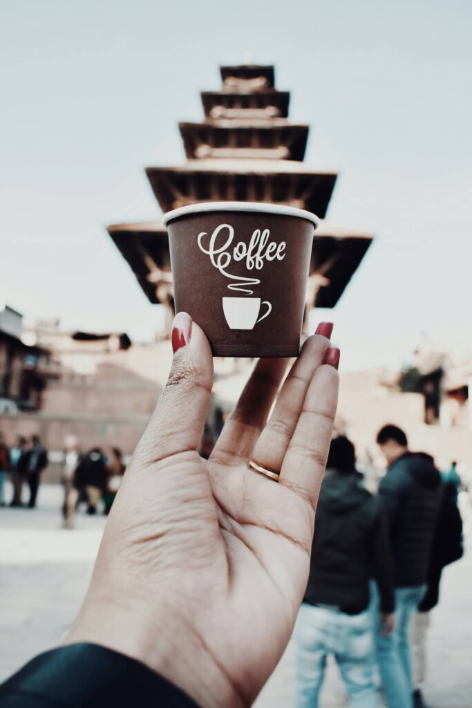 tourist holding coffee cup in Bhaktapur, Nepal