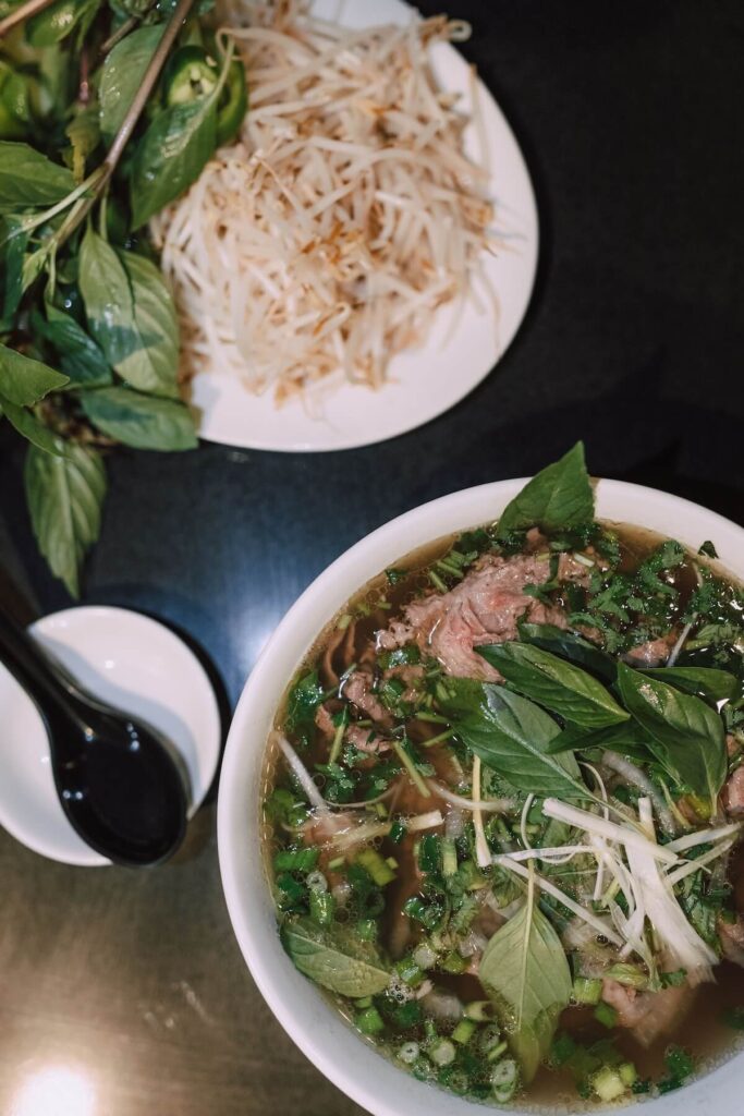 bowl of pho and vegetables