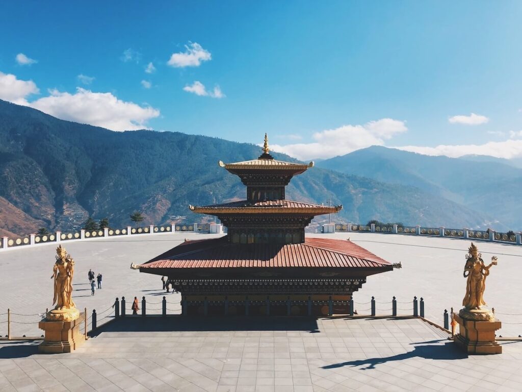 Changangkha Temple surrounded by statues and mountains in Thimphu, Bhutan